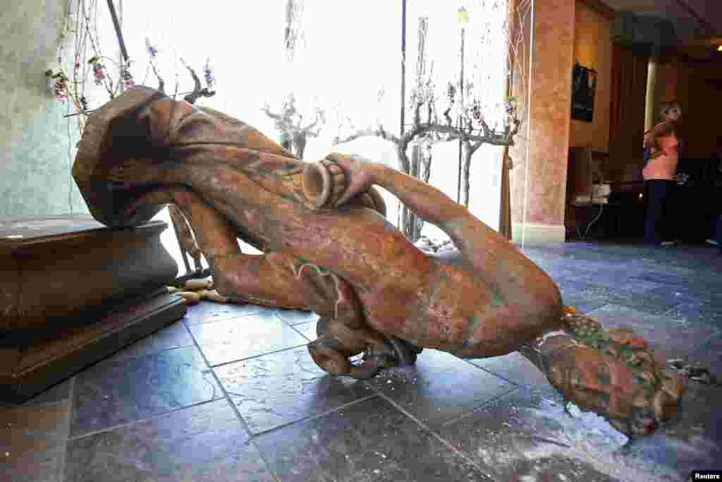 A fallen statue of Bacchus, a Roman god of wine,inside the Ceja Vineyards tasting room after an earthquake in Napa, California, Aug. 24, 2014.