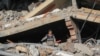 A youth salvages items from the rubble of a building destroyed in Israeli strikes in Deir el-Balah in the central Gaza Strip on Nov. 5, 2024.