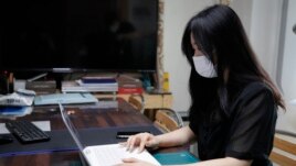 Han Shin Bi, a high school senior in Seoul, demonstrates how to take online classes after an interview in Seoul, South Korea, on Sept. 18, 2020. “Online classes were really inconvenient,” said Han. Experts say the reduced interaction with teachers, digita