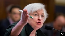 FILE - Federal Reserve Chair Janet Yellen, shown testifying on Capitol Hill in July, links future interest rate increases to the U.S. inflation rate, which she says has been held down by temporary factors.