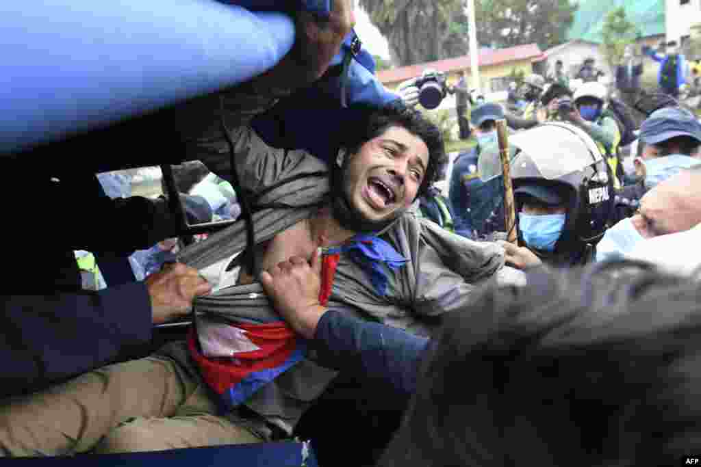 A demonstrator calls out as police seize him during a protest against India&#39;s new road to the Chinese border, in Kathmandu, Nepal.