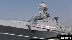 FILE - Indian Navy personnel board the newly built INS Kochi, a guided missile destroyer, during a media tour at the naval dockyard in Mumbai, Sept. 28, 2015. 