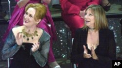 FILE - In this March 23, 2003, photo, actresses Meryl Streep, left, and Barbra Streisand applaud on stage during a reunion of past Oscar winners during the 75th Academy Awards in Los Angeles, California.