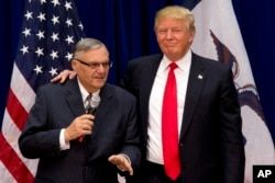 FILE - Republican presidential candidate Donald Trump is joined by Maricopa County, Ariz., Sheriff Joe Arpaio at a campaign event in Marshalltown, Iowa, Jan. 26, 2016.