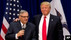 FILE - Then Republican presidential candidate Donald Trump is joined by then Maricopa County, Arizona, Sheriff Joe Arpaio at a campaign event in Marshalltown, Iowa, Jan. 26, 2016.