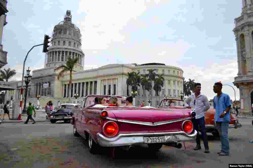 People gather on the street in Old Havana. U.S. President Barack Obama is scheduled to visit the historic area shortly after his arrival late Sunday afternoon.