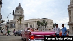 People gather on the street in Old Havana. 