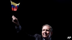 Venezuela's opposition leader Edmundo Gonzalez waves a Venezuelan flag during a meeting with supporters in Panama City, Jan. 8, 2025. 