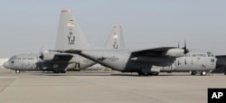 FILE - U.S. Air Force C-130 Hercules transport planes park on the tarmac of Yokota Air Base in Tokyo during a U.S.-Japan joint military exercise, Dec. 6, 2010.