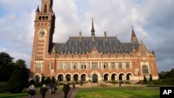 People walk toward the International Court of Justice in the Hague, the Netherlands, Aug. 27, 2018. Iran is going to the United Nations' highest court in a bid to have U.S. sanctions lifted.