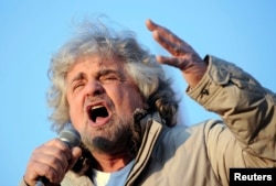 Five-Star Movement leader and comedian Beppe Grillo gestures during a rally in Turin, Italy, Feb. 16, 2013.