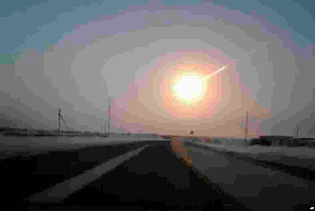 A meteorite contrail is seen in this frame grab made from a video, on a highway from Kostanai, Kazakhstan, to Chelyabinsk region, Russia, provided by Nasha Gazeta newspaper. A meteor streaked across the sky of Russia&#39;s Ural Mountains, causing sharp explosions and reportedly injuring more than 1,000 people, including many hurt by broken glass.