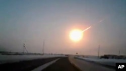 In this frame grab made from a video done with a dashboard camera, on a highway from Kostanai, Kazakhstan, to Chelyabinsk region, Russia, provided by Nasha Gazeta newspaper, February 15, 2013 a meteorite contrail is seen. A meteor streaked across the sky