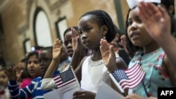 Children take the Oath of Allegiance as they become U.S. citizens during a citizenship ceremony at The Bronx Zoo, May 5, 2017, in The Bronx borough of New York City.