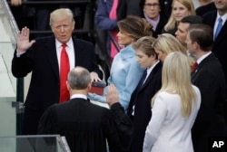 Donald Trump is sworn in as the 45th president of the United States by Chief Justice John Roberts as Melania Trump looks on during the 58th Presidential Inauguration at the U.S. Capitol in Washington, Jan. 20, 2017.