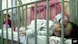 FILE - An infant infected with rotavirus sleeps at the San Rafael hospital in Santa Tecla, El Salvador, Feb. 19, 2004.