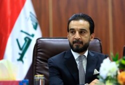 FILE - Iraqi Parliament Speaker Mohamed al-Halbousi attends a meeting in Basra, 340 miles (550 km) southeast of Baghdad, Iraq, Sept. 18, 2018.