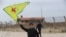 FILE - A Syrian Kurd waves the flag of YPG (People's Protection Units) near Qamishli's airport in northeastern Syria on December 8, 2024, following the fall of the capital Damascus to anti-government fighters.
