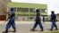 FILE - Riot police walk outside the Radio Publique Africaine broadcasting studio in Burundi's capital, Bujumbura, Apr. 26, 2015. 