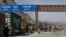 Trucks carrying NATO supplies wait in line at the Pakistan-Afghan border area of Torkham