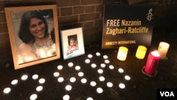 FILE - Flowers and photos at a vigil for Nazanin Zaghary-Ratcliffe, a British-Iranian woman detained in Iran, are seen in this Jan. 16, 2017 photo.