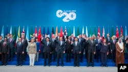 Leaders pose for a group photo at the G20 summit in Brisbane, Australia, Saturday, Nov. 15, 2014. 