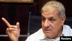 FILE - Egypt's outgoing Housing Minister Ibrahim Mahlab -- named as the country's new prime minister -- talks during an interview with the media in Cairo, September 2012.