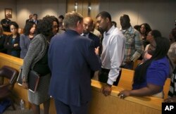 Lead prosecutor Michael Snipes, second from left, and Dallas County DA Faith Johnson, left, talk to Odell and Charmaine Edwards after Roy Oliver was sentenced to 15 years in prison for the murder of their son Jordan Edwards, Aug. 29, 2018, in Dallas.