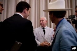 FILE - In this photo taken July 16, 2016, Roger Stone, center, who then was an adviser to Donald Trump, speaks to reporters in New York. Stone says he believes his contacts with a Russian-linked hacker who took credit for breaching the Democratic National Committee were obtained through a FISA warrant.