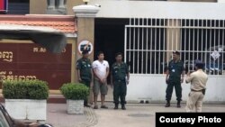 Kung Raiya, standing in front of the Phnom Penh Municipal Court, was arrested this week after attempting to sell t-shirts on Facebook with images of slain political commentator Kem Ley, Phnom Penh, Cambodia, July 10, 2019. 