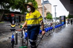 A Brisbane City Council worker wears a mask along the Queen Street Mall in Brisbane on Jan. 8, 2021, as Australia's third-largest city headed into lockdown.