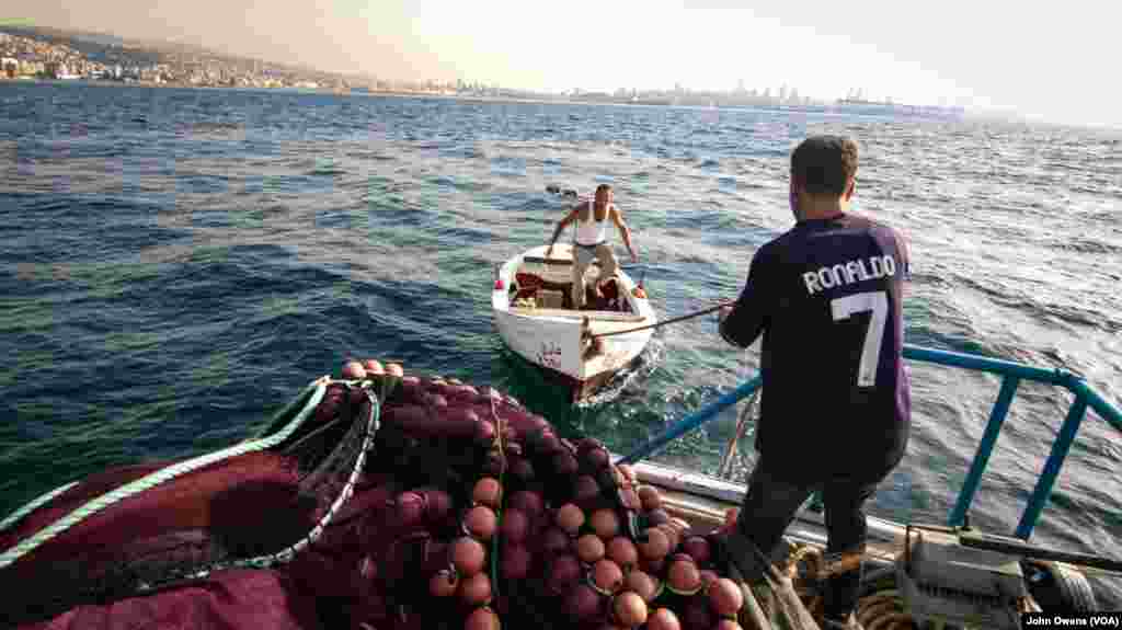 Fishermen head out to sea off the coast of Beirut. They say fish spawning grounds have been destroyed by the land reclamation.