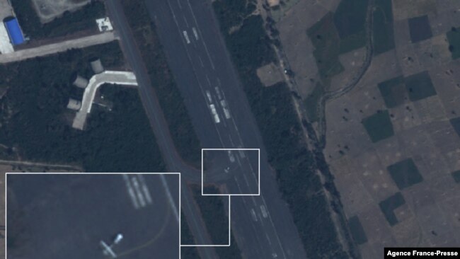 This handout satellite image taken on December 2, 2021 by Planet Labs PBC shows what Dutch peace organization PAX says is a drone with the measurement that fits the Iranian Mohajer-6 on the tarmac at Harar Meda air base in Bishoftu. (Planet Labs PBC / AFP)