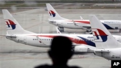 FILE - Fleet of Malaysia Airline planes on the tarmac of the Kuala Lumpur International Airport, in Malaysia, Jan. 29, 2015. Australian and Malaysian investigators are eager to examine what may be debris from Malaysia Airlines flight MH370.