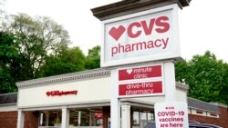 FILE: Vehicles are parked in front of a CVS Pharmacy in Mount Lebanon, Pa., on May 3, 2021.