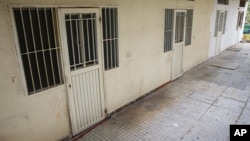 This April 7, 2016 photo shows barred rooms of the Chez Maurice Hotel in Maamelteine north of Beirut, Lebanon. Lebanese security forces have busted a sex trafficking ring involving 75 Syrian women trafficked to Lebanon from their country and forced into prostitution. 