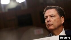 Former FBI Director James Comey pauses as he testifies before a Senate Intelligence Committee hearing on Russia's alleged interference in the 2016 U.S. presidential election on Capitol Hill in Washington, June 8, 2017. 