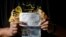 Alberto Herrera, 35, of Chicago shows his boarding pass and water-damaged passport a day after surviving the crash of Aeromexico flight 2431 just after takeoff, in Durango, capital of Durango state, Mexico, Aug. 1, 2018. 