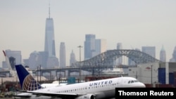 FILE - A United Airlines passenger jet takes off with New York City as a backdrop. Airline stocks sank Nov. 26, 2021, in response to news that a new COVID variant had been detected. United shares fell 9.6%, and American Airlines shares fell 8.8%.