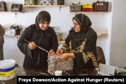 Syrian refugee Sahira Zoubi works on a new handbag, made from recycled newspapers, at an up-cycling workshop in Irbid city, northern Jordan, May 9, 2018.