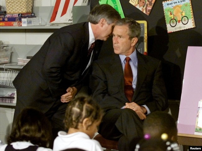 Bush listens as a White House official tells him a second plane hit the World Trade Center on Sept. 11, 2001. (REUTERS/Win McNamee/Pool photo)