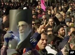 This frame grab from video provided by Iran Press, a pro-government news agency based in Beirut, shows pro-government demonstrators marching in, Arak, Iran, Jan. 3, 2018. Tens of thousands of Iranians took part in pro-government demonstrations in several cities.