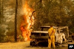   Un bombero observa las llamas de un incendio en California, el 28 de julio de 2018. 