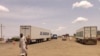 FILE - Trucks carrying foreign humanitarian aid pass by Gedaref on the main road linkin the Sudanse capital Khartoum with Port Sudan on July 10, 2023.