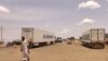 FILE - Trucks carrying foreign humanitarian aid pass by Gedaref on the main road linkin the Sudanse capital Khartoum with Port Sudan on July 10, 2023.