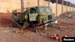 A damaged military truck that belonged to forces loyal to Syria's President Bashar al-Assad is seen in Qarmeed camp after Islamist rebel fighters took control of the area, April 26, 2015. A coalition of Islamist rebels seized the army base in northwestern