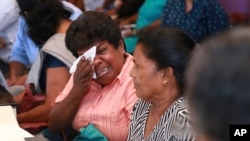 Samudra Bulathasinhala, in pink, a relative of a crew member captured by Somali pirates, cries during a meeting with Sri Lankan shipping authorities in Colombo, Sri Lanka, March 16, 2017. 