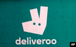 FILE - A Deliveroo logo is seen on a bicycle in London, July 11, 2017.