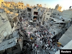 FILE —Palestinians search for casualties at the site of Israeli strikes on houses in Jabalia refugee camp, amid the ongoing conflict between Israel and Hamas, at the Indonesian hospital, in the northern Gaza Strip November 18, 2023.