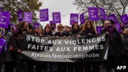 French actress Muriel Robin, center, marches with participants holding a banner that reads "Stop violence toward women" as they take part in a demonstration in Paris, Nov. 24, 2018. 